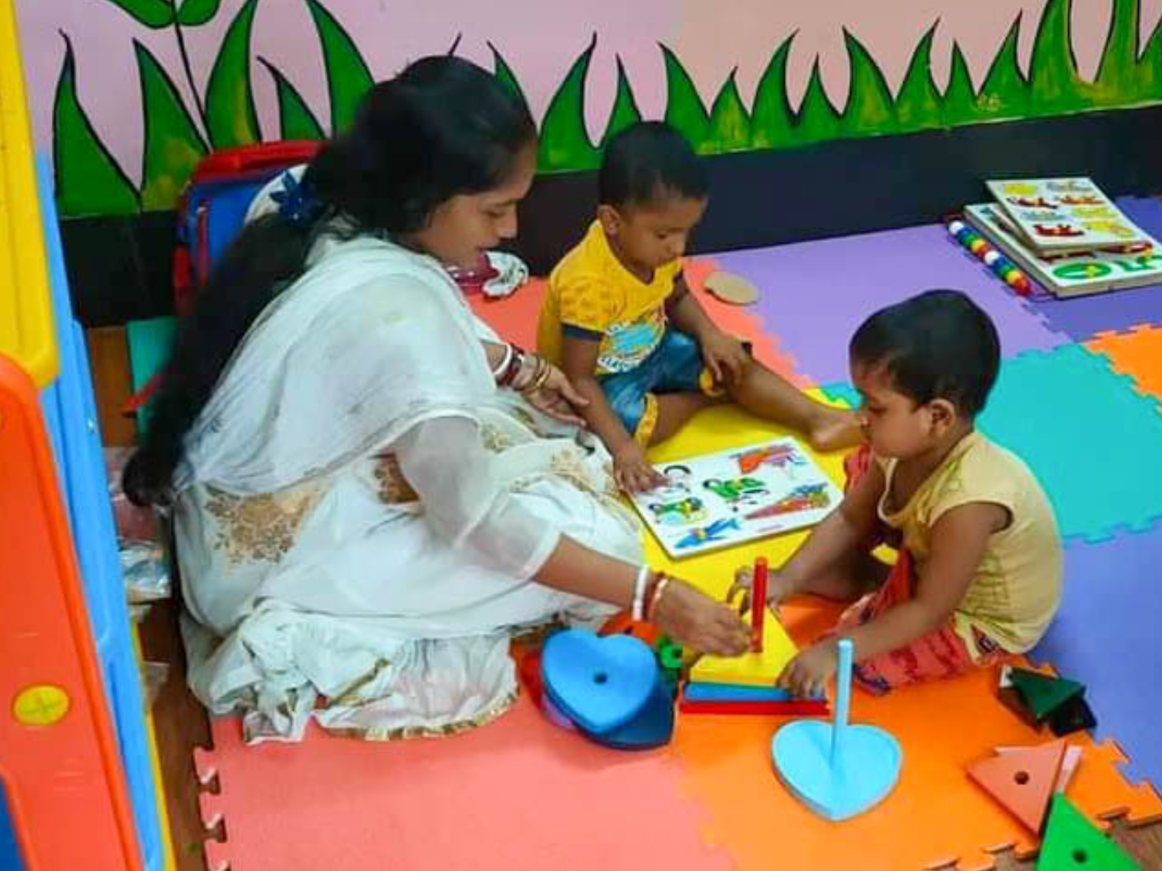 Child working with Montessori materials during training session